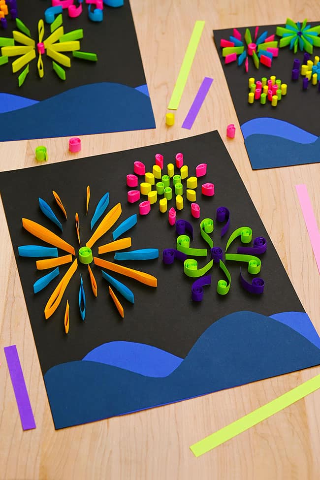 Paper Fireworks Craft Colorful paper fireworks crafts on a wood background