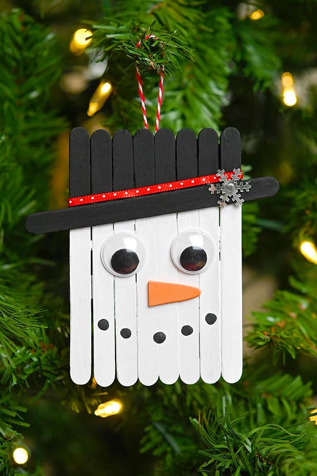 Popsicle Stick Snowman Ornament Popsicle stick snowman ornament hanging on a Christmas tree