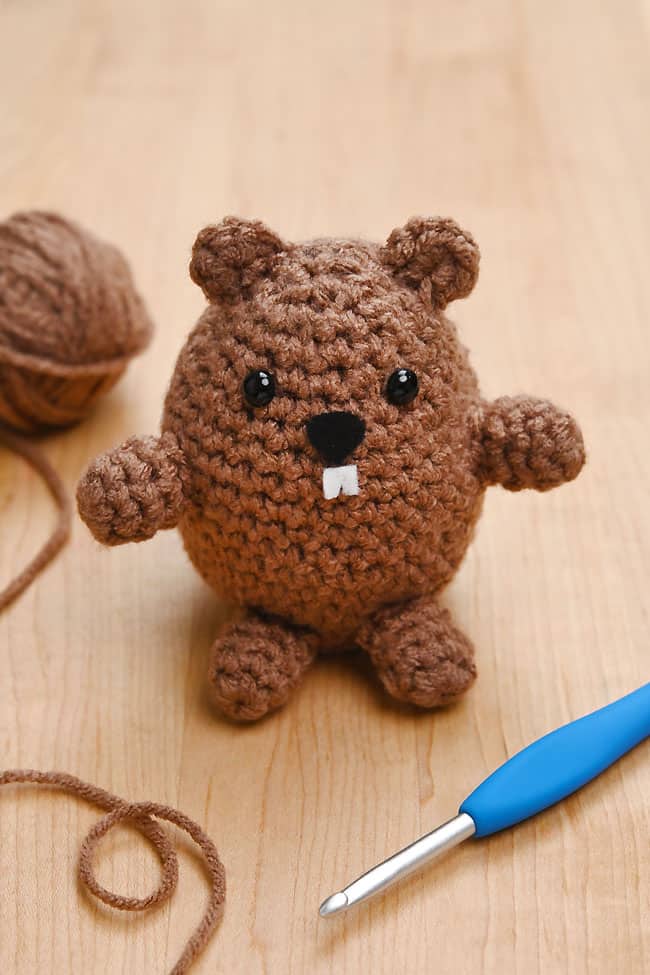 Crocheted Groundhog Groundhog crochet toy beside supplies to make one