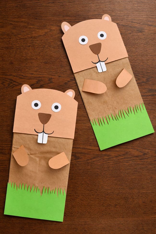 Groundhog Paper Bag Craft Groundhog crafts made from template pieces sitting on a brown wood background