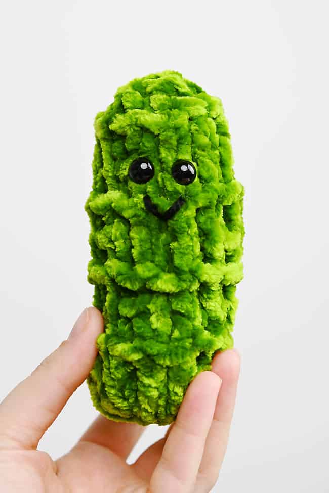 Holding a loom knit pickle pal