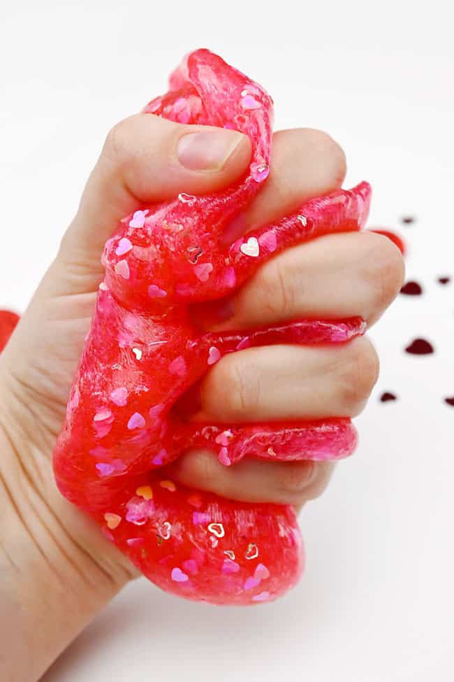 Valentine Slime for Kids Squishing Valentine's slime in hand