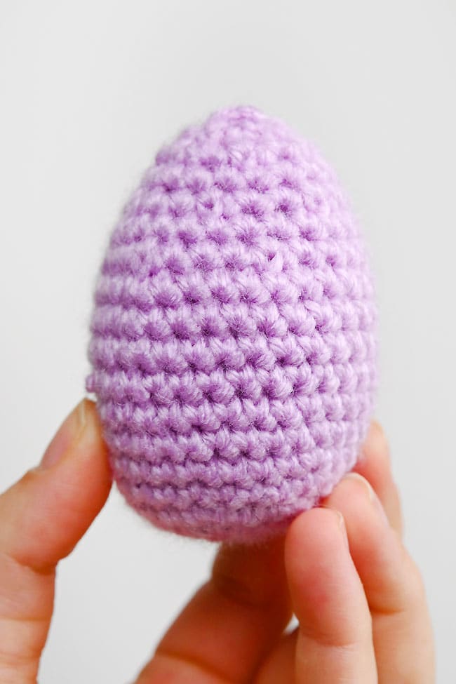 Crochet Easter Egg Holding a purple crochet Easter egg made with our free pattern