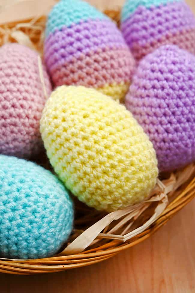 Crochet Easter Eggs Cute pastel crochet Easter eggs in a straw basket
