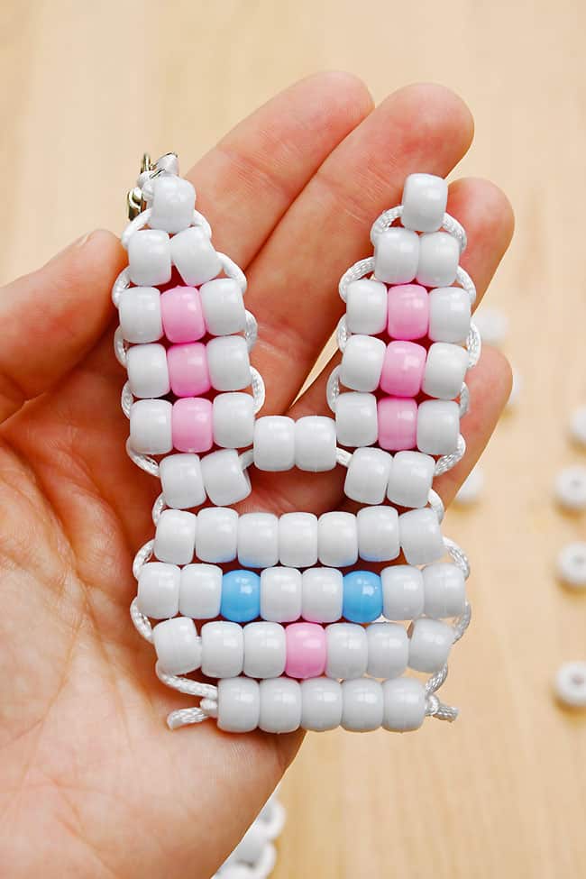 Holding a pony bead bunny keychain