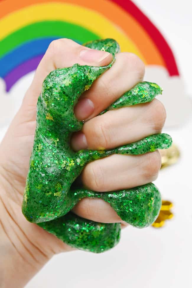 St Patrick's Day Slime Recipe Squishing glitter glitter slime in a hand