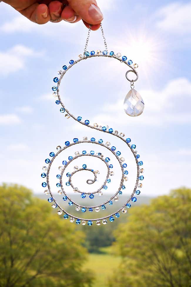 Bead and Wire Suncatchers A bead and wire suncatcher shaped like an 'S' with blue and clear beads on it