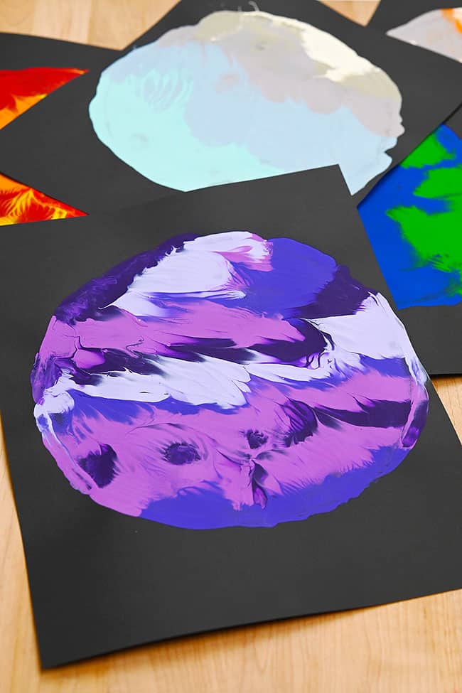 Planet Art Prints Closeup on a purple planet made with paint transfer from a paper plate