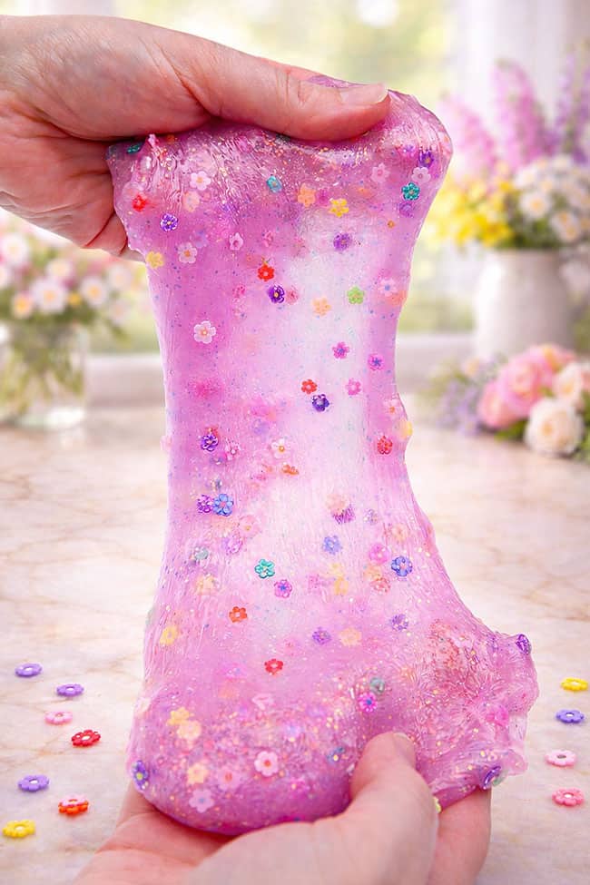 Stretching out spring slime with flower confetti in it