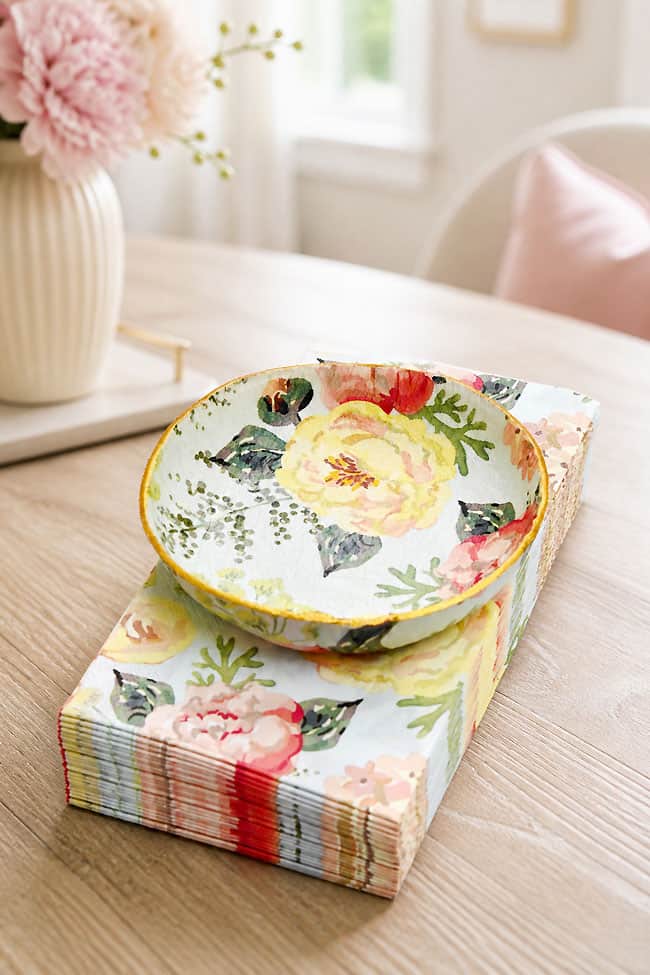 Air Dry Clay Bowl Napkin Transfer DIY clay bowl on a pile of patterned napkins