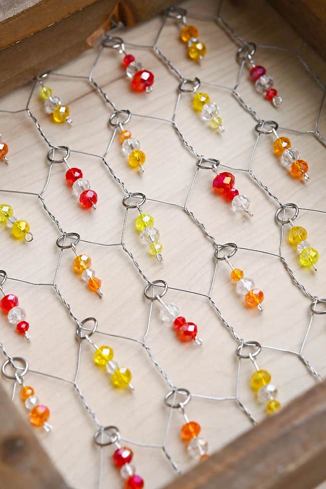 Chicken Wire Bead Suncatcher Closeup on a chicken wire suncatcher with red, orange, and yellow beads