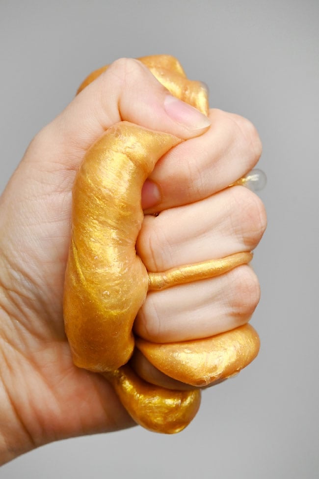 DIY Gold Slime Squishing DIY gold slime in hand