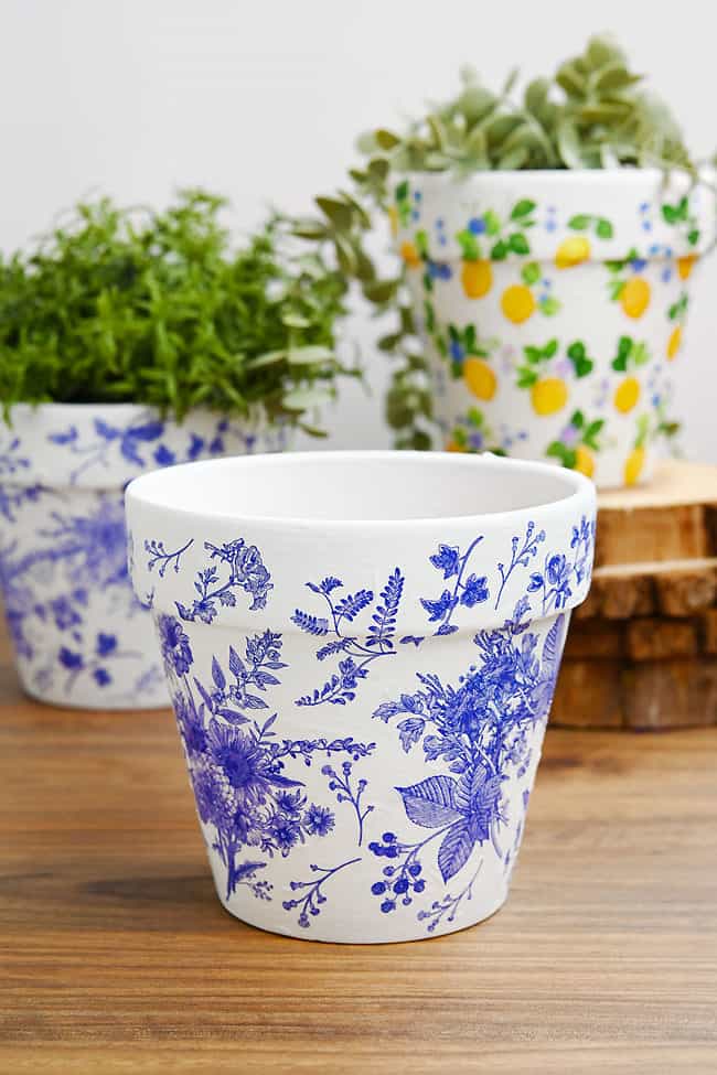 Decoupage Plant Pots Focus on a decoupage plant pot with a blue floral nature pattern