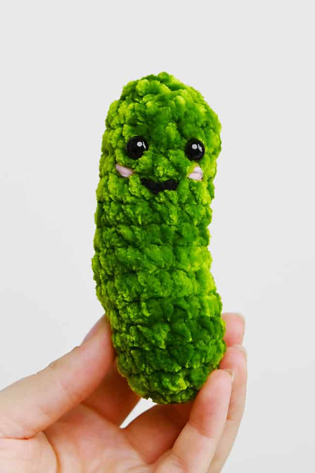 Free Crochet Pickle Pattern Holding an adorable crochet pickle made with our free pattern