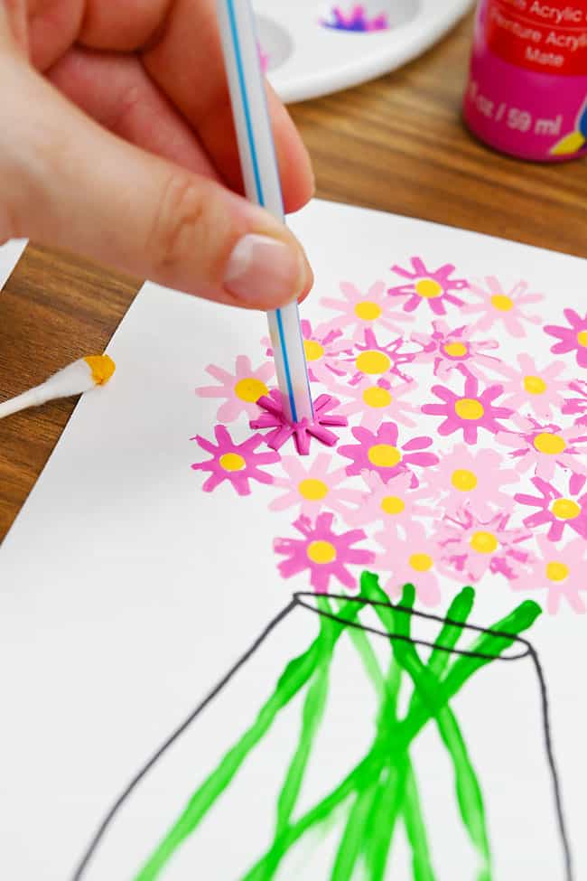 Painting Flowers with Straws Adding a pink flower with a straw paintbrush to a vase of flowers picture