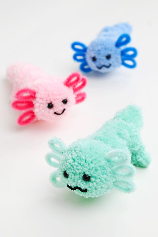 Axolotl Craft Group of pom pom axolotl in pastel shades of yarn