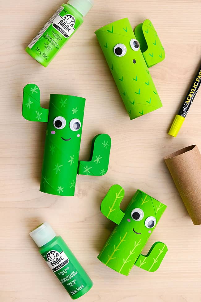 Cactus Craft for Kids Lay flat image of paper roll cactuses on a wood background