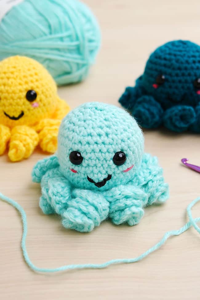 Crochet Octopus Pattern Group of colorful crochet octopus plushies made with our free pattern