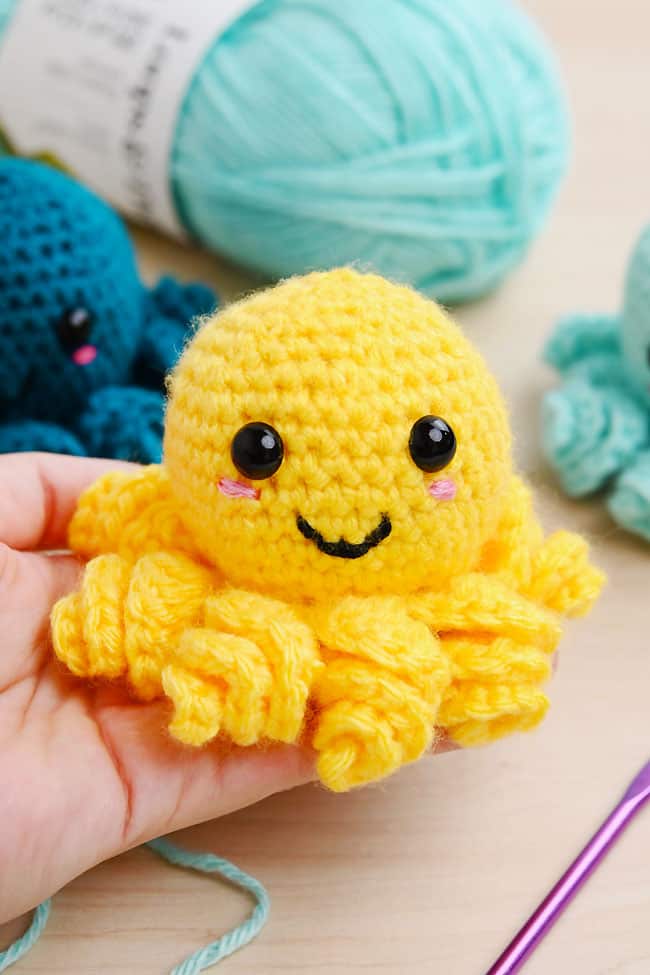 Crochet Octopus Holding a yellow crochet octopus amigurumi