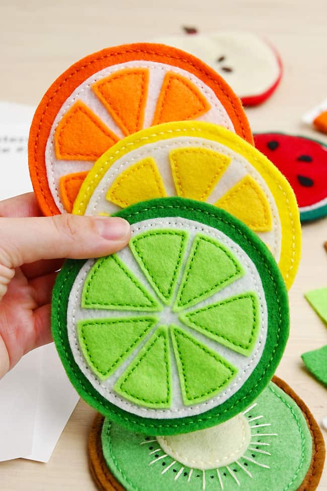 DIY Felt Coasters Holding colourful citrus coasters made from felt