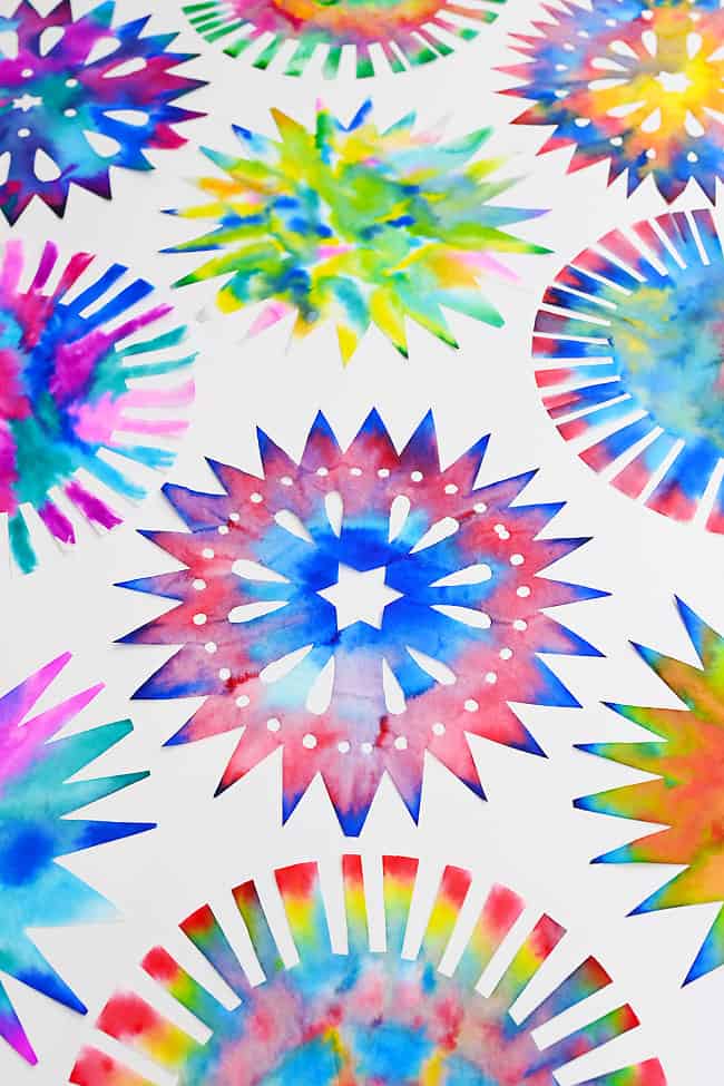 Firework Coffee Filter Colorful fireworks shapes made with coffee filters and markers sitting on a white background