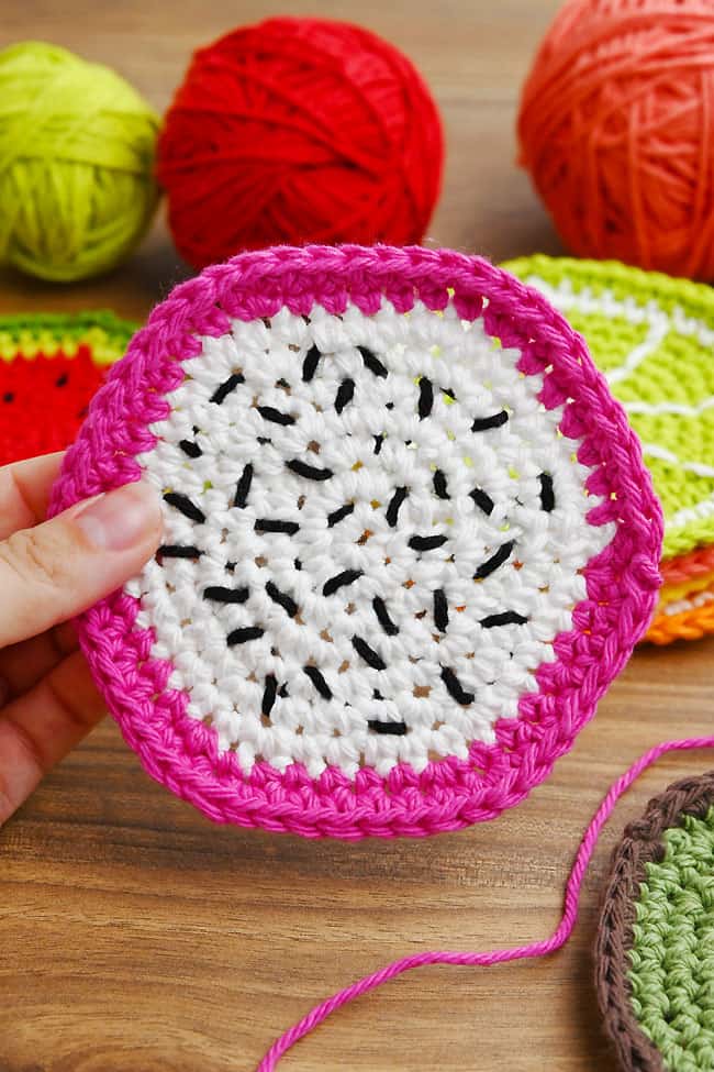 Crochet Fruit Coasters Pattern Closeup of holding a dragon fruit crochet coaster