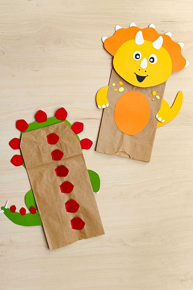 Dinosaur Puppet Template Showing a triceratops and the back of a stegosaurus paper bag dinosaur puppet