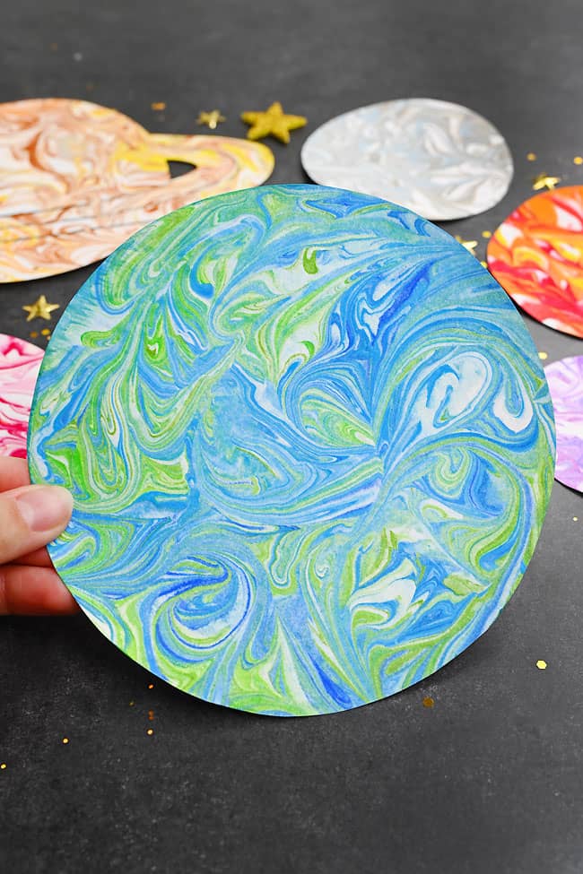 Marble Paint Planets Closeup holding marbled planet Earth