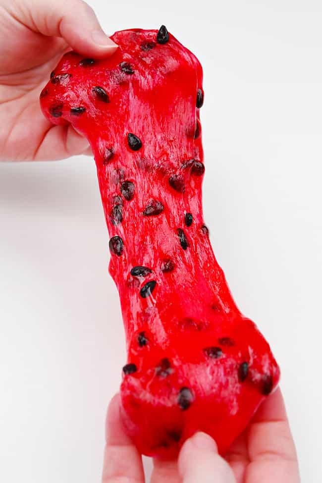 Watermelon Slime Stretching red watermelon slime with black clay seeds