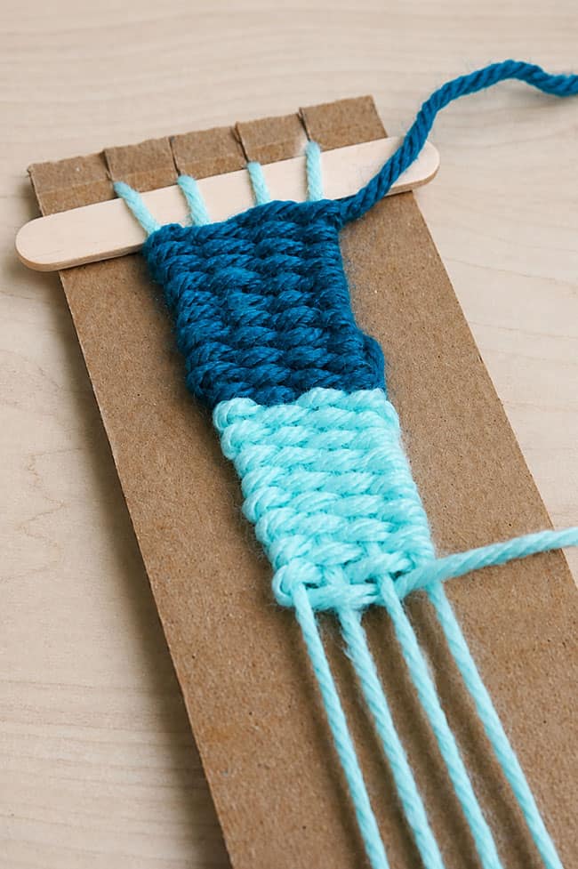 How to Make a Cardboard Loom Making a yarn bracelet on a cardboard loom