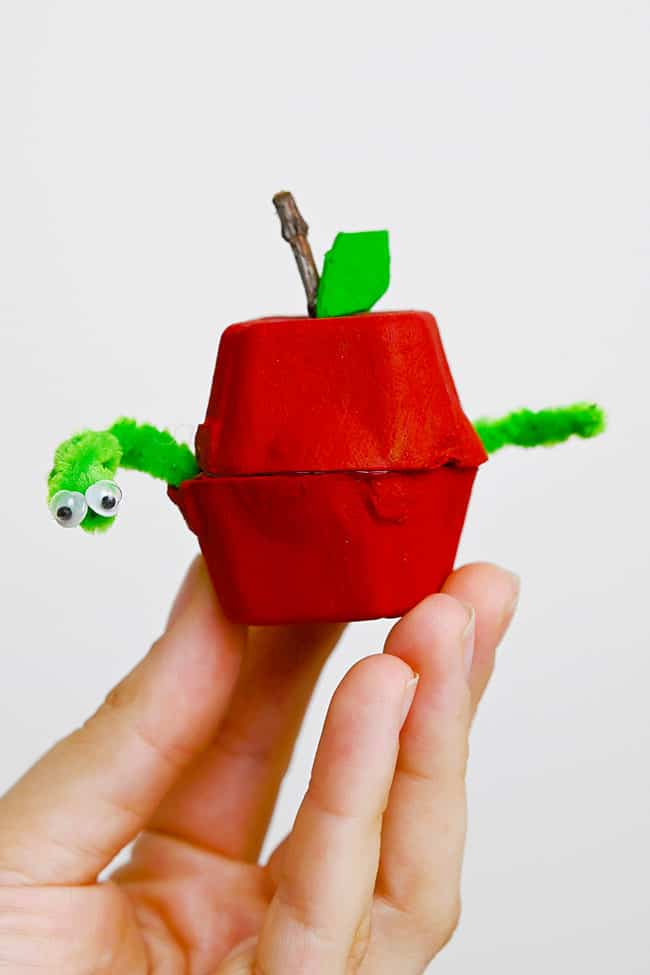 How to Make an Egg Carton Apple Red egg carton apple craft with a pipe cleaner worm