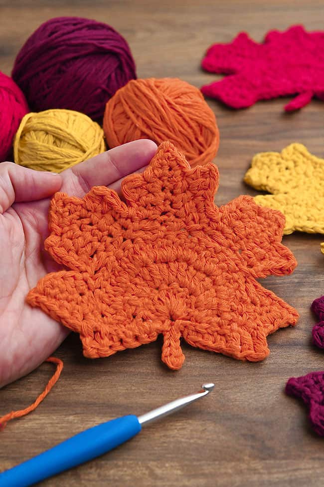 Crochet Leaf Coaster Closeup on an orange maple leaf coaster