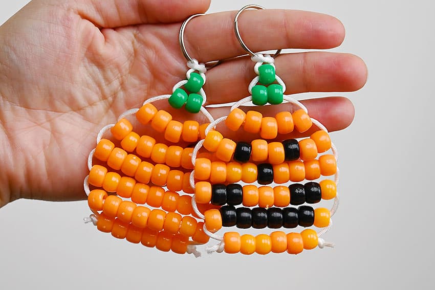Holding cute pony bead pumpkin and jack-o-lantern keychains