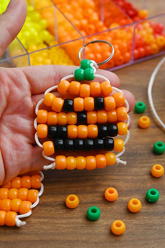 Pony Bead Pumpkin Craft Holding a pony bead jack-o-lantern