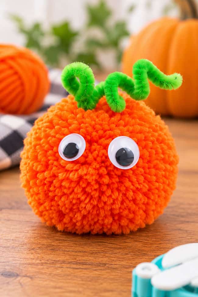 Halloween Pom Pom Crafts Pom pom jack-o-lantern pumpkin character with a pipe cleaner vine