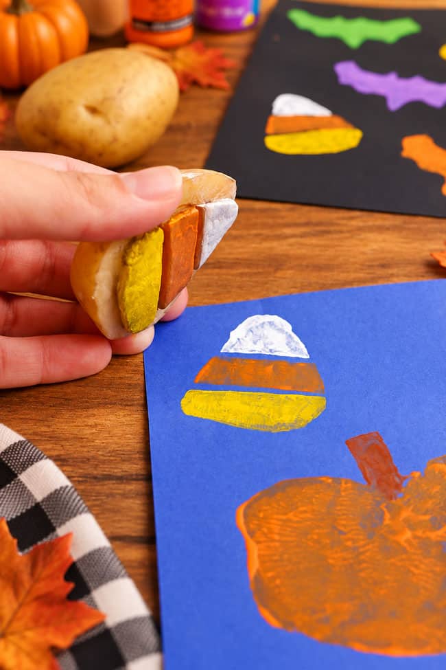 Halloween Potato Printing Making a candy corn stamp with a potato and paint